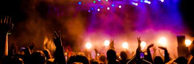 Crowd at concert with colorful stage lights